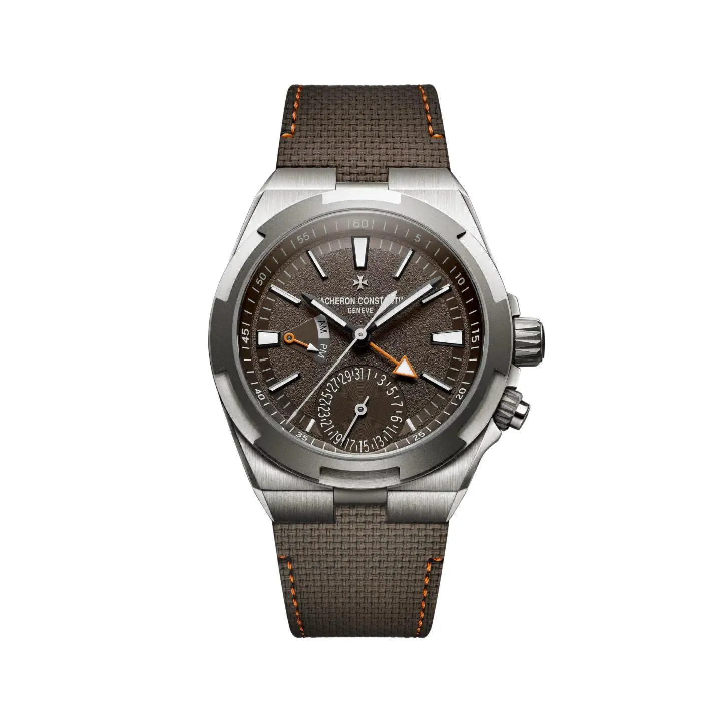 Reloj de lujo Vacheron Constantin Overseas Dual Time con esfera marrón texturizada, aguja GMT con punta de flecha naranja, subesfera de fecha y correa estructurada marrón con pespuntes naranjas.